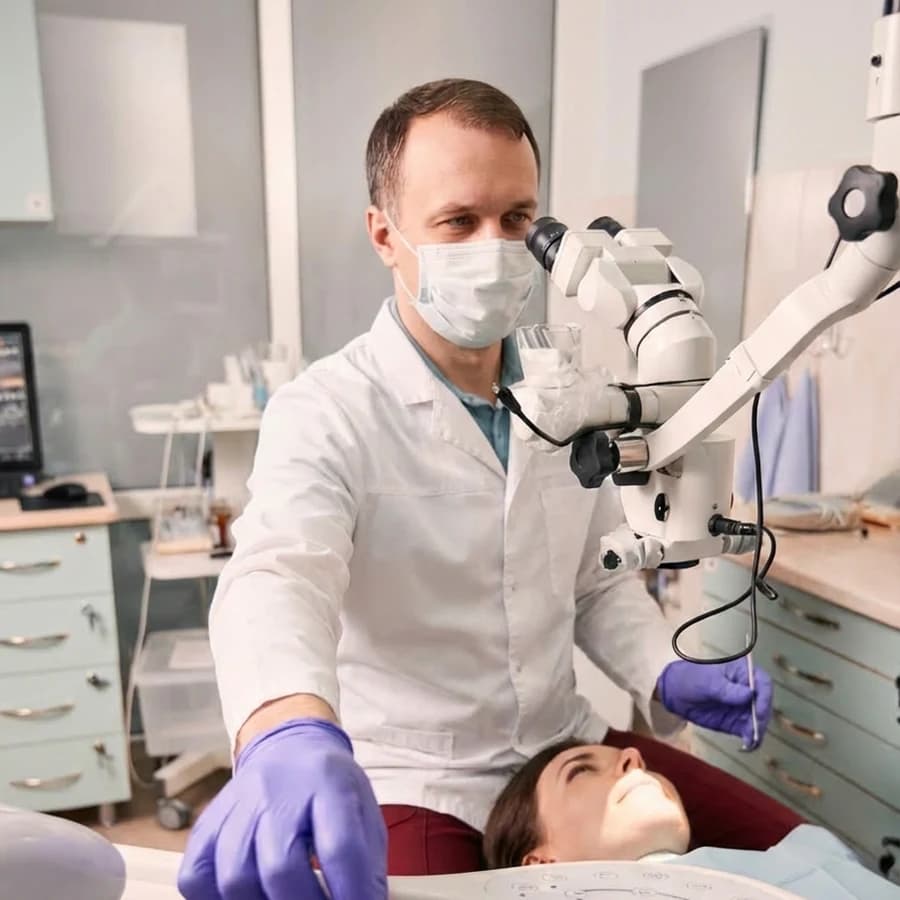 Dr. Ion Rotaru working at a dental operating microscope in the Tampa operatory